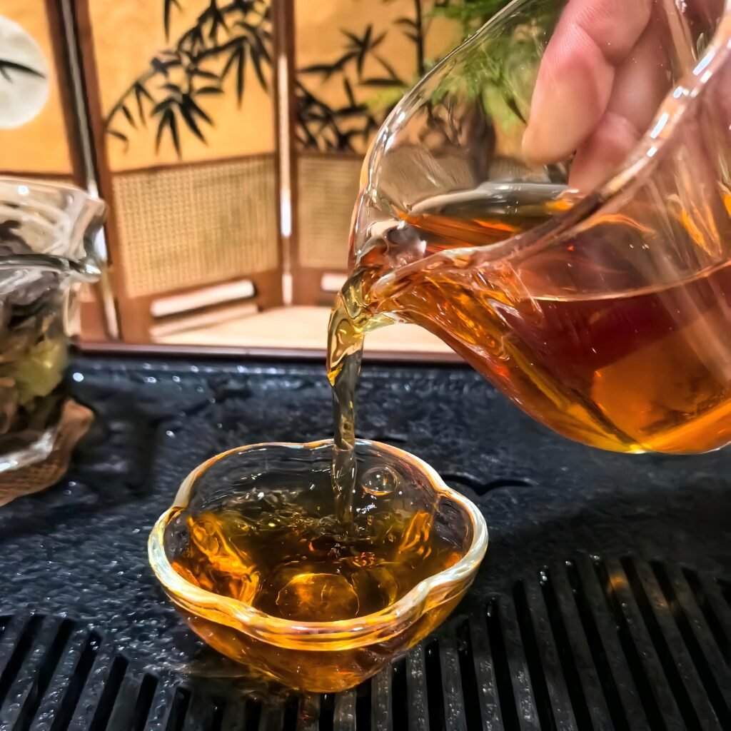 Amber tea liquor of 5-year aged Shou Mei white tea in a white porcelain cup