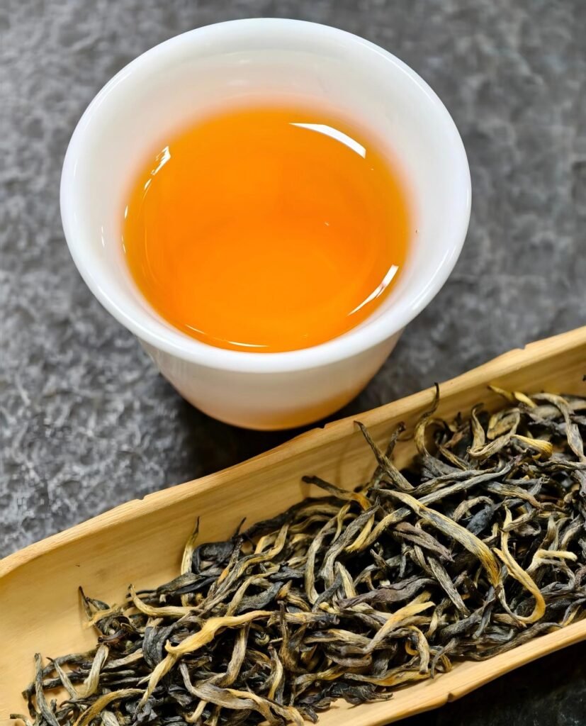 Brewed Jin Jun Mei 2026 in glass teapot showing golden halo liquor