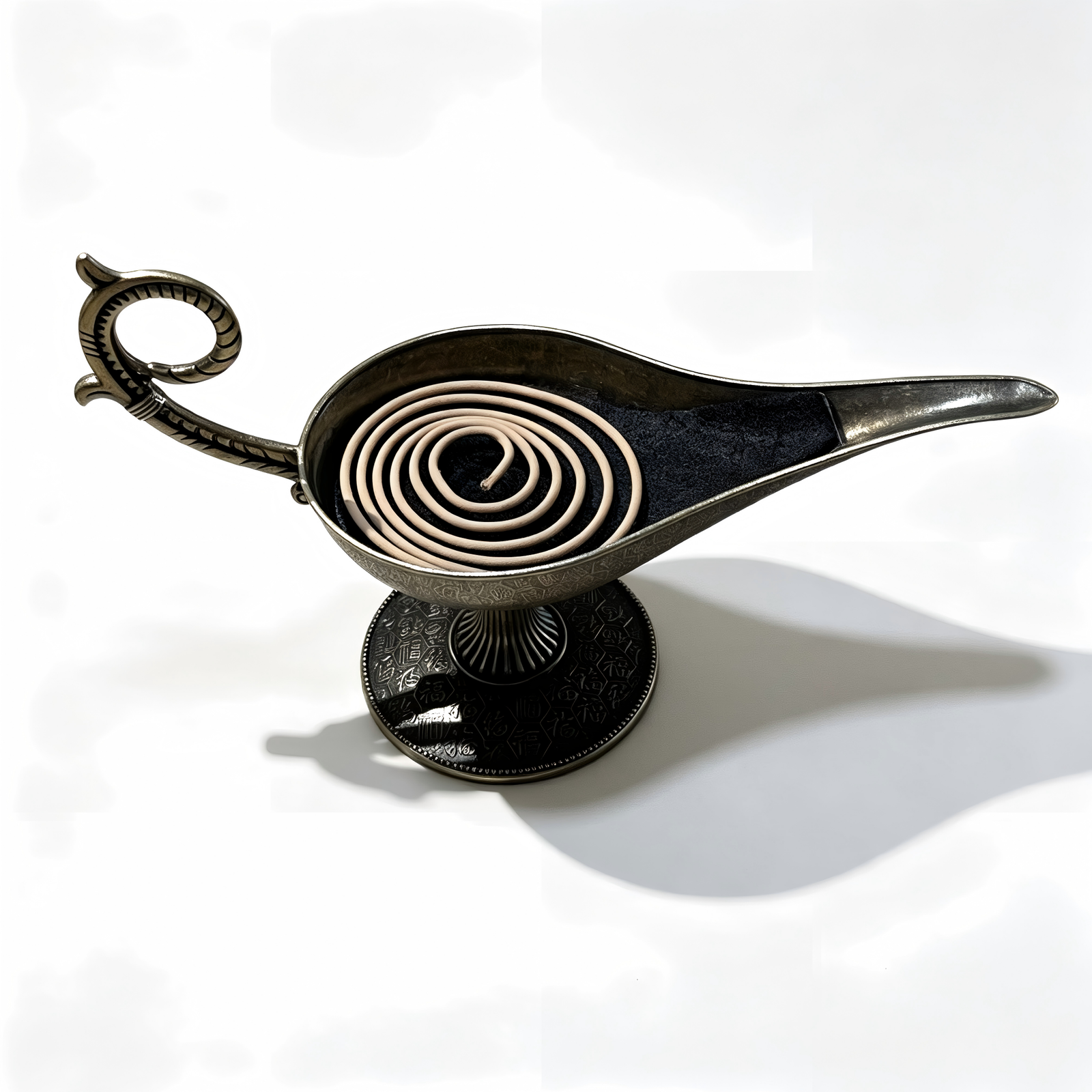 An overhead exploded view of the antique bronze Aladdin lamp incense burner, showcasing the open ash basin layered with fine black incense sand, the detached intricate filigree lid, and a natural brown coil incense beneath on a pure white background.