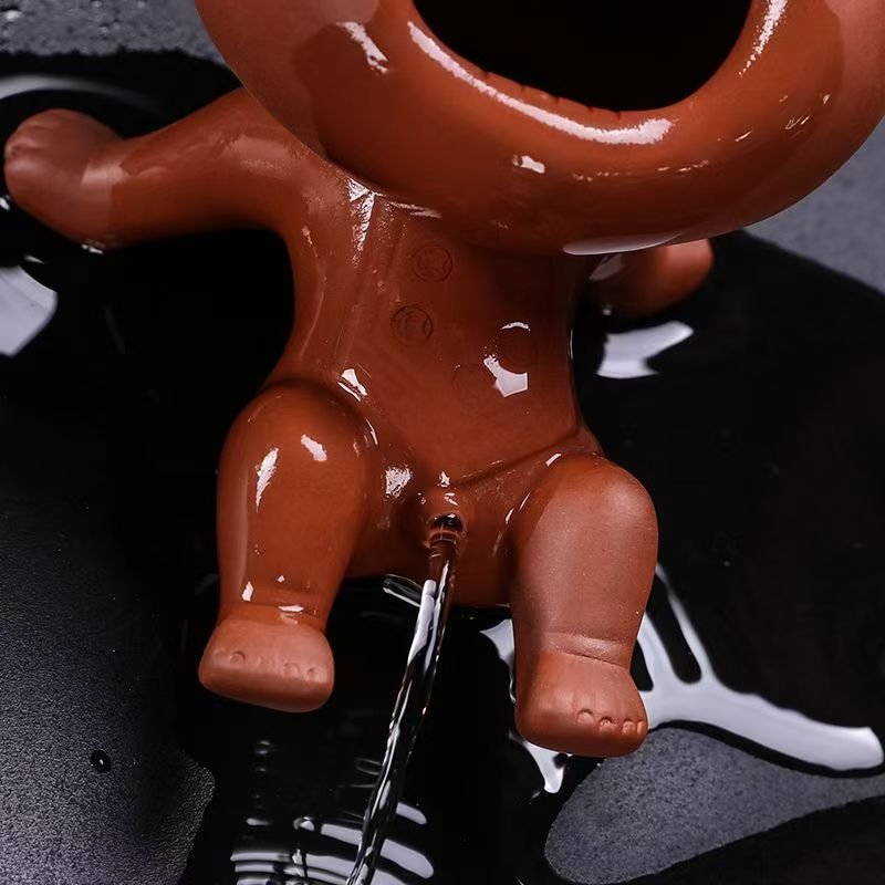 Traditional water-spitting mechanism activated on a unglazed Zhu Ni clay tea pet.