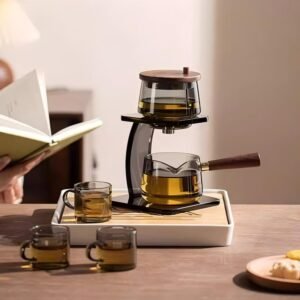 Minimalist automatic glass tea set with side handle pitcher and wooden accents for office brewing.