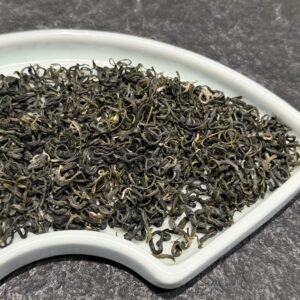 Hand-rolled spiral leaves of authentic Dongting biluochun green tea displaying delicate white downy hairs.