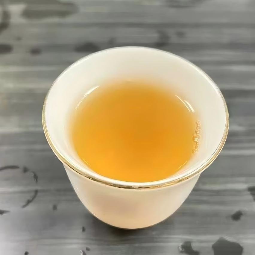 Pale yellow-green liquor of young Bai Mu Dan Tea in a glass pitcher