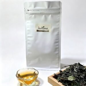 Loose leaf 2026 Fuding Shoumei white tea displayed on a woven bamboo tray.